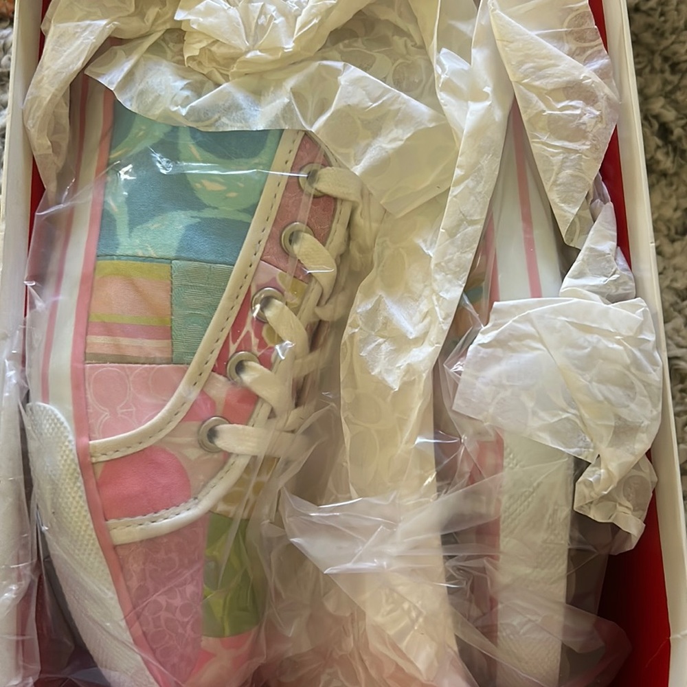 Coach sneakers in box.. excellent condition. Never worn